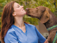 Photo: dog licking chin of vet student