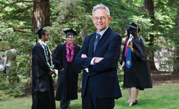 Photo: Sullivan with graduating students in caps and gowns in background