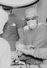 Photo: Doctor in surgical gown and mask