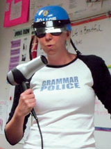 Photo: Author wearing a police helmet and T-shirt that reads Grammar Police, blowing on the end of a blow dryer