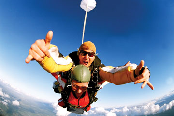 Photo: tandem skydivers give thumbs up