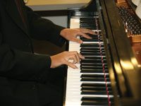 Photo: hands on piano keyboard