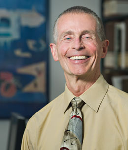 Portrait photo: the doctor, smiling, and wearing dress shirt and tie