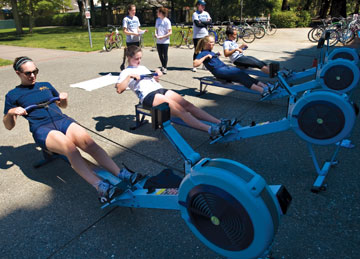 Photo: Members of women's rowing team on rowing machines