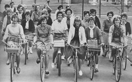 smiling young women on bikes