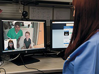 Photo: health care provider consulting with doctor and patient via video conference