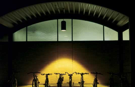 Photo of a row of bikes bathed in amber light