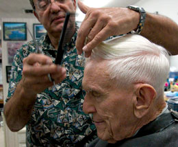 Photo: barber John Salido cutting hair of Emanuel Epstein