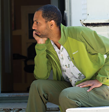 Photo: Tarver sitting on porch, leaning head on right hand
